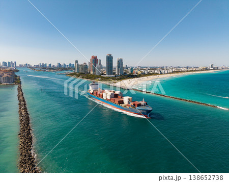 Freight container loaded on cargo vessel. Aerial view cargo ship leaving harbor. Cargo business. Container ship. Shipping logistics. Commercial shipping. Cargo ship in sea, aerial view Freight container loaded on cargo vessel. Aerial view cargo ship leaving harbor. Cargo business. Container ship. Shipping logistics. Commercial shipping. Cargo ship in sea, aerial view 138652738