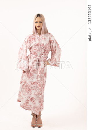 Fashionable blonde woman in floral robe standing in studio 138653165