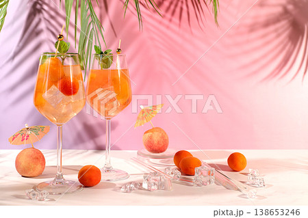 Modern still life with fruits. Royal lemonade cocktail with peach, apricot, mojito with tequila, gin, rum, ice and fresh mint, bar and party concept, restaurant and cafe advertising card 138653246