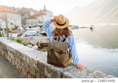 A woman tourist walks and enjoys the views and attractions. Travelling, lifestyle, adventure. A woman tourist walks and enjoys the views and attractions. Travelling, lifestyle, adventure. 138653406