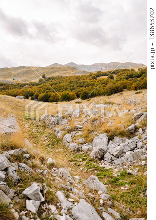 Scenic landscape of rocky terrain and autumn foliage in serene countryside setting during weather Scenic landscape of rocky terrain and autumn foliage in serene countryside setting during weather 138653702
