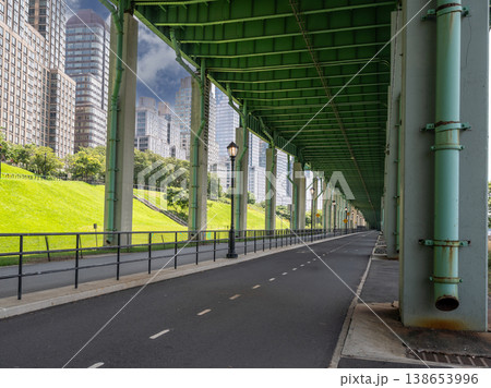 New york, usa august 14,2024. Hudson river greenway path under bridge with manhattan skyline, concrete columns, railings and streetlights, peaceful summer day New york, usa august 14,2024. Hudson river greenway path under bridge with manhattan skyline, concrete columns, railings and streetlights, peaceful summer day 138653996