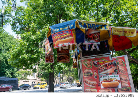 New york, usa august 14,2024. Hot dog stand offering classic new york style street food, with menu signs featuring hot dogs, pretzels, and italian sausage 138653999