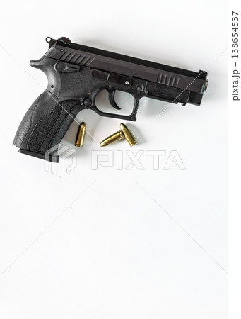 Modern black metal gun with three bullets, white space for text below Modern black metal gun with three bullets, white space for text below 138654537
