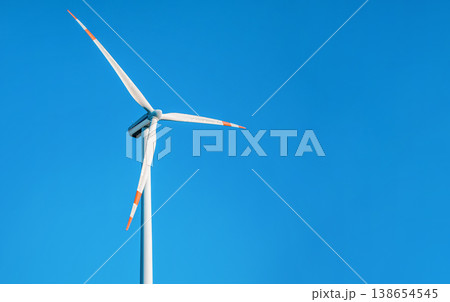 Single wind electricity power turbine against clear blue sky Single wind electricity power turbine against clear blue sky 138654545