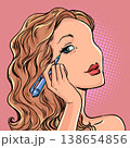Pop Art Retro A woman paints her eyes. Beauty care products. Creating your own look. 138654856