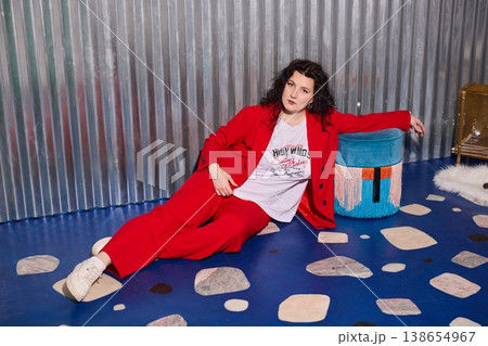 Caucasian woman interior stylist in red suit with ottoman 138654967