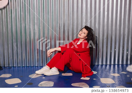 Confident woman in red with composed demeanor and friendly aura 138654973
