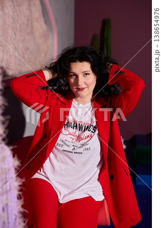 Relaxed lady in colorful environment showcasing playful attitude 138654976