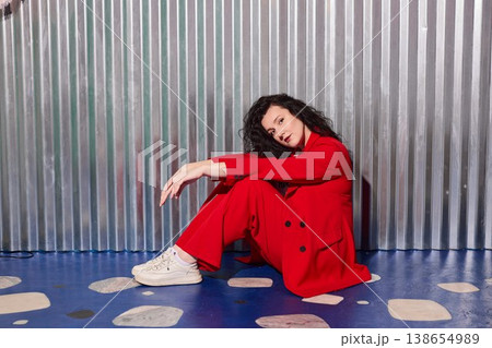 Contemplative woman in lively studio environment with sneakers Contemplative woman in lively studio environment with sneakers 138654989