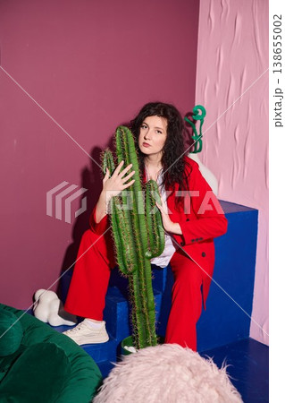 High fashion woman paired with cactus in artistic setting High fashion woman paired with cactus in artistic setting 138655002