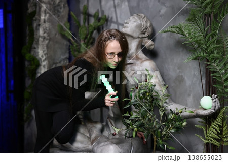 Dedicated field archaeologist notes details of mossy monument 138655023