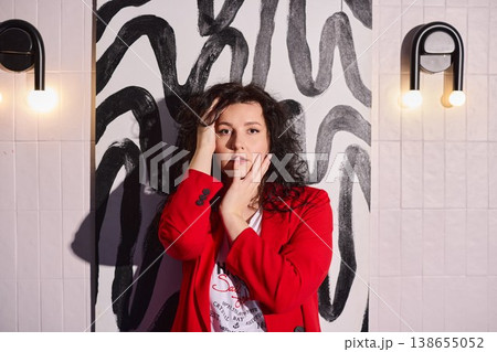 Creator dressed in striking crimson attire captured in mural setting Creator dressed in striking crimson attire captured in mural setting 138655052