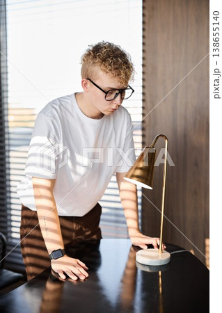 Concentrated young man examining study...の写真素材 [138655140] - PIXTA