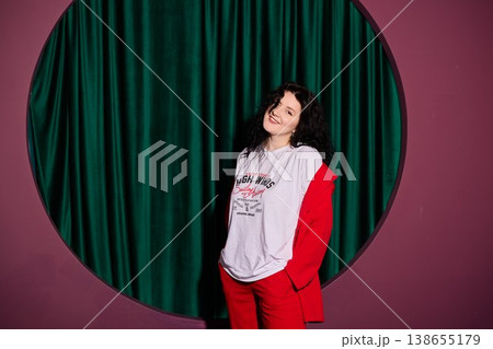 Classic actress in vibrant clothing amidst velvet curtain setting Classic actress in vibrant clothing amidst velvet curtain setting 138655179