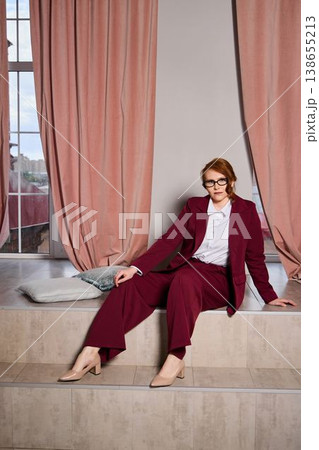 Entrepreneur sitting calmly overlooking city with laptop and coffee 138655213