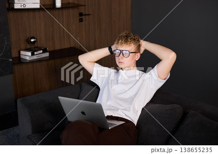 Vibrant young person resting while engaged with technology 138655235