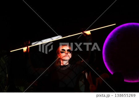 Sleek figure with fiery hair and purple halo in ritual setting Sleek figure with fiery hair and purple halo in ritual setting 138655269