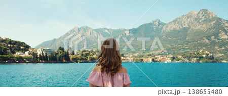 Summer vacation, beautiful woman tourist stands enjoying amazing sea landscape, mountains background Summer vacation, beautiful woman tourist stands enjoying amazing sea landscape, mountains background 138655480