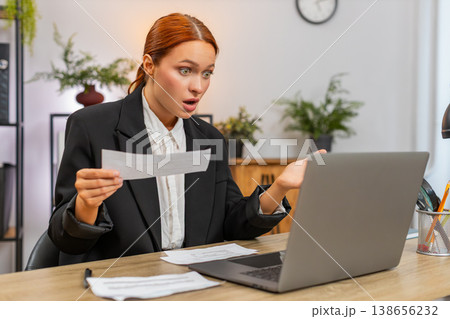 Young businesswoman finds unpaid bill makes rapid transfer on laptop sighs with relief after success 138656232