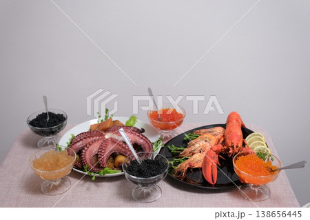 octopus Lobster and assorted seafood caviar shrimp on table gourmet fresh luxury appetizer platter home kitchen close-up 138656445
