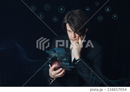 スマートフォンでネットワークを操作し考え込むビジネスマン、IoTとスマート生活の象徴 138657054