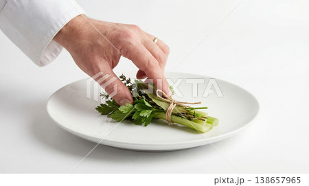 Chef garnishing plate with fresh herbs and greens fine dining main course restaurant preparation presentation culinary professional ingredient vegetable rosemary aromatic fragrant Chef garnishing plate with fresh herbs and greens fine dining main course restaurant preparation presentation culinary professional ingredient vegetable rosemary aromatic fragrant 138657965