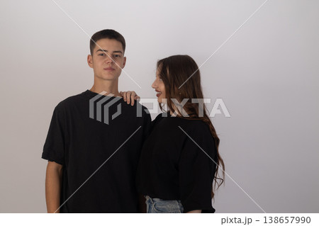 Young man and woman standing together in studio Young man and woman standing together in studio 138657990