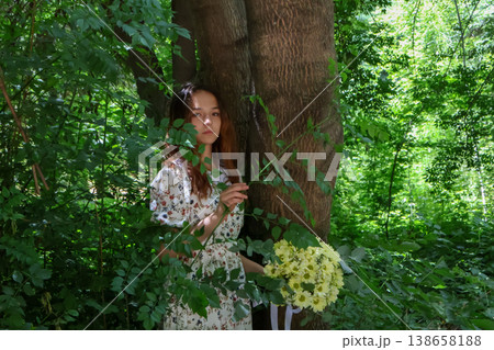 Woman holding a bouquet of flowers in the woods 138658188