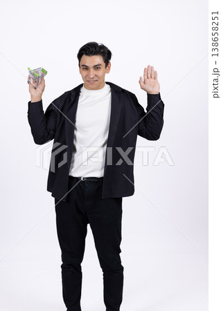 Businessman in black suit holding money in hands 138658251