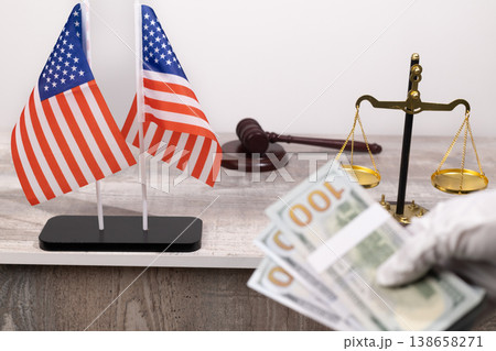 Justice scales with money and american flags 138658271