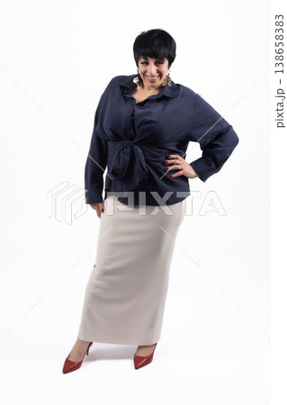 Woman in dark shirt and long skirt posing from the back 138658383