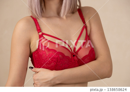 Close up of woman in red lace bra posing in studio Close up of woman in red lace bra posing in studio 138658624