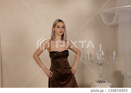 Pretty woman in dark nightgown posing with hands on hips Pretty woman in dark nightgown posing with hands on hips 138658805