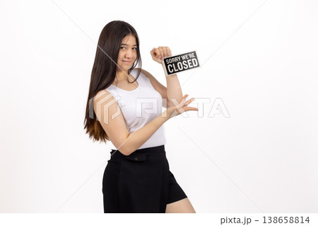 Woman in white shirt holding a small sign that says CLOSED Woman in white shirt holding a small sign that says CLOSED 138658814