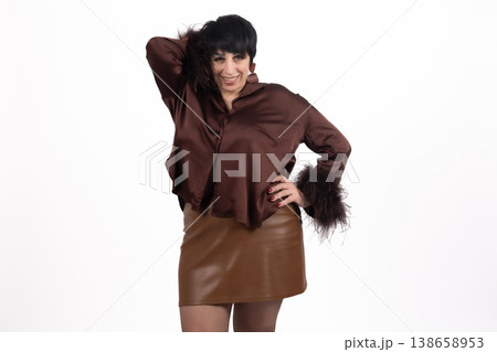 Woman in brown satin shirt and leather skirt looking away Woman in brown satin shirt and leather skirt looking away 138658953