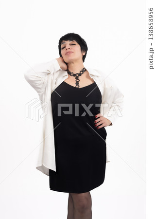 Confident woman in black dress and white shirt posing Confident woman in black dress and white shirt posing 138658956