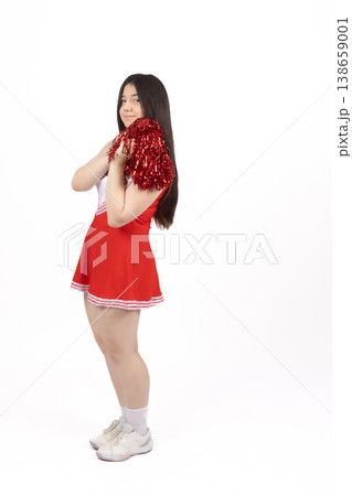 Young woman in red dress standing and looking away Young woman in red dress standing and looking away 138659001