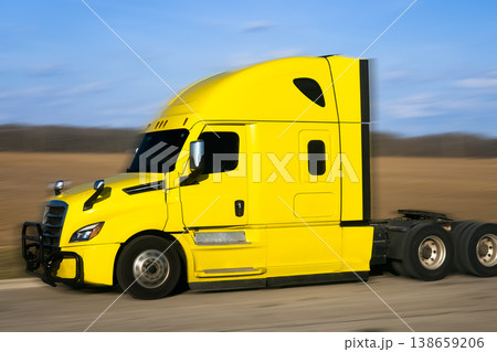Detailed side profile of a yellow truck cabin on a spring field Detailed side profile of a yellow truck cabin on a spring field 138659206
