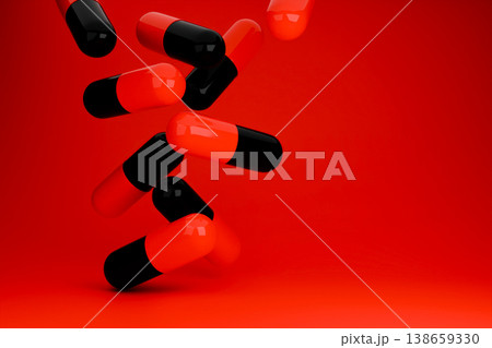 Red and black capsules falling on a bright red surface 138659330