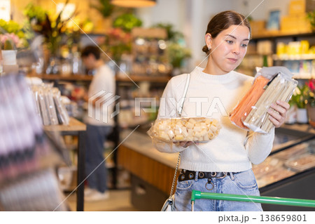 Young woman choosing pasta in grocery supermarket Young woman choosing pasta in grocery supermarket 138659801