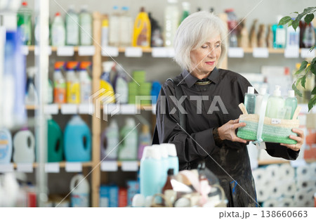 Elderly woman buyer chooses cosmetics gift set Elderly woman buyer chooses cosmetics gift set 138660663
