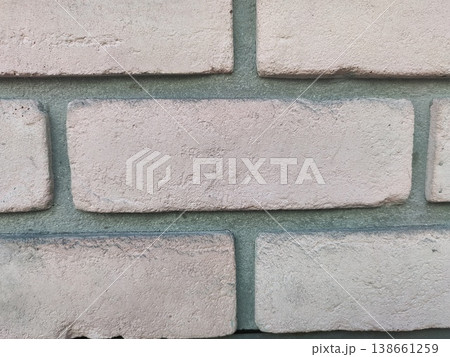 Close-Up View of Texture and Color Variation of Light Pink and Beige Brick Wall with Subtle Mortar Grout Lines for Home or Architectural Use 138661259