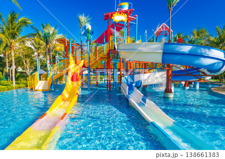 children's water park in the pool at resort on summer vacation. Colorful big aquapark with slides for kids children's water park in the pool at resort on summer vacation. Colorful big aquapark with slides for kids 138661383