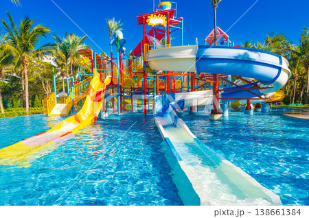 children's water park at the resort on summer vacation. Colorful aquapark with slides for kids in pool children's water park at the resort on summer vacation. Colorful aquapark with slides for kids in pool 138661384