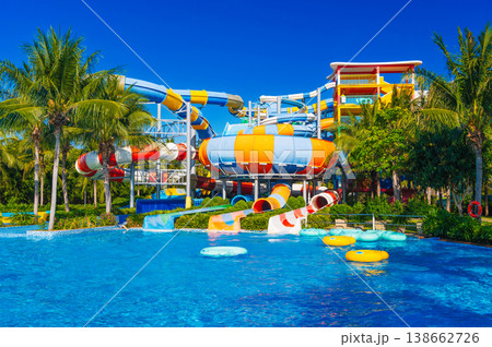 water park with slides and pipes for active extreme recreation at the resort in summer. Big colorful aquapark with a pool in the tropics water park with slides and pipes for active extreme recreation at the resort in summer. Big colorful aquapark with a pool in the tropics 138662726