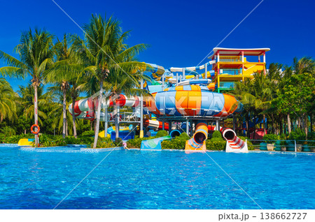 water park in pool at resort on summer vacation. Colorful aquapark with slides water park in pool at resort on summer vacation. Colorful aquapark with slides 138662727