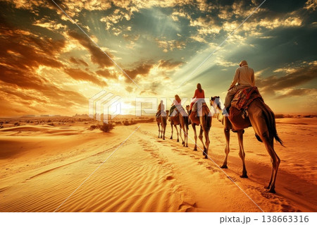 Family Riding Camels Through the Golden Desert at Sunset with Dramatic Skies and Serenity 138663316