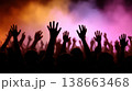 Joyful Crowd Celebrating at a High-Energy Concert with Colorful Strobe Lights and Smoke Effects 138663468