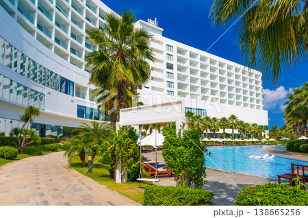 luxury hotel with a swimming pool and palm trees in summer resort in Asia 138665256